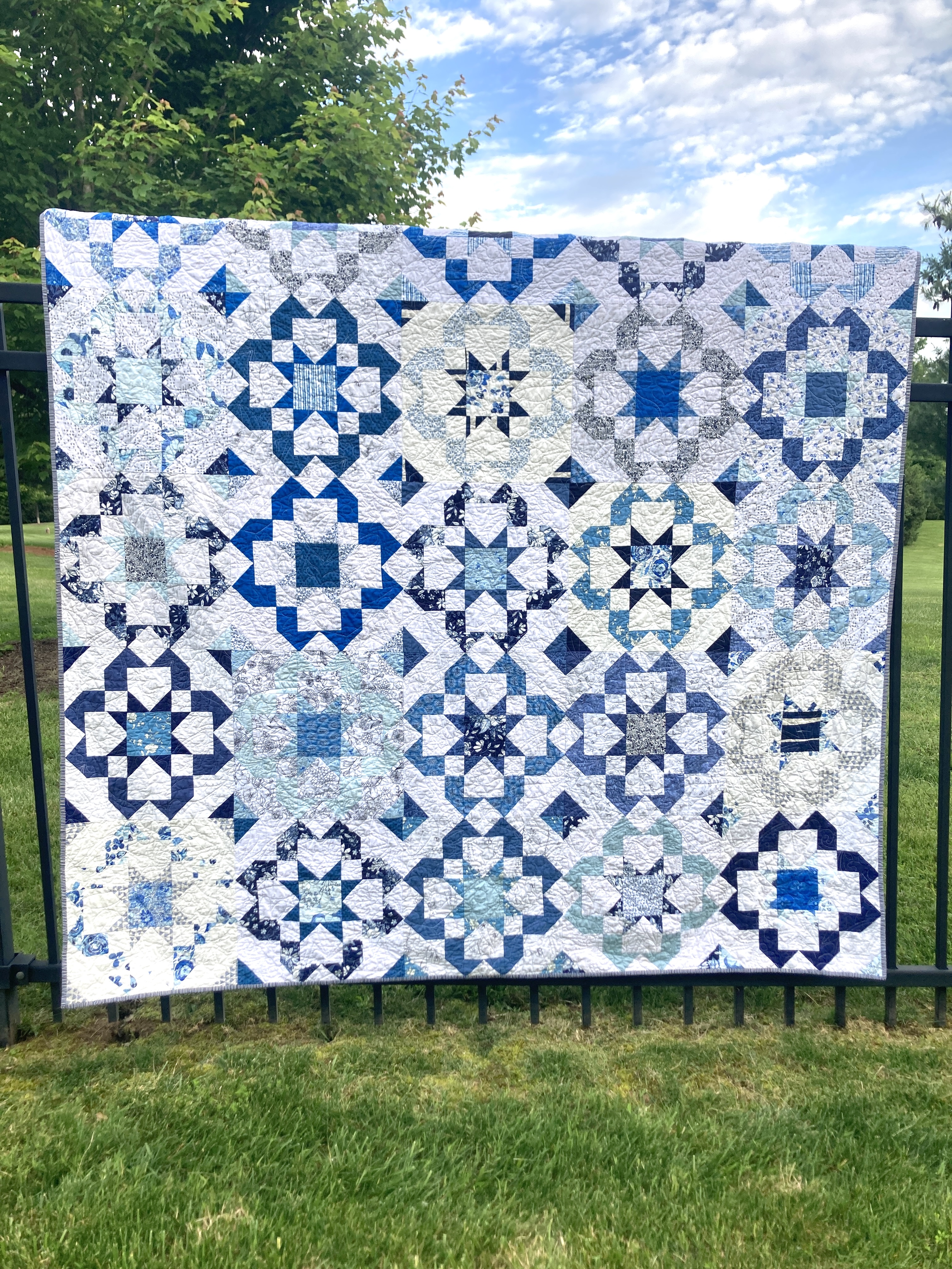 A scrappy quilt in blues with a bloom burst pattern